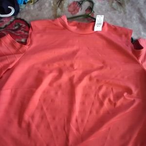 A peach shirt with sleeve on off shoulder